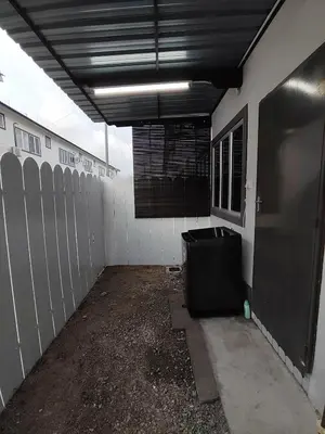 an empty garage with a black trash can in it at Homestay in manjung pr1ma segari-Melayu only in Lumut