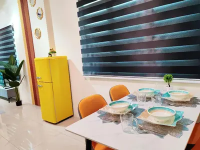 a white table with chairs and a yellow cabinet at Pavilionvillie M1T692 by irainbow in Ipoh