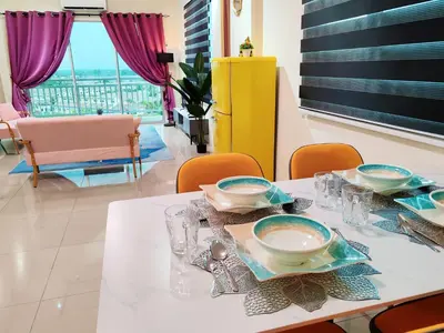 a dining room with a table with plates and glasses at Pavilionvillie M1T692 by irainbow in Ipoh