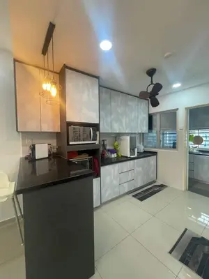 a kitchen with stainless steel cabinets and a black counter top at coolvibes homes in Cameron Highlands