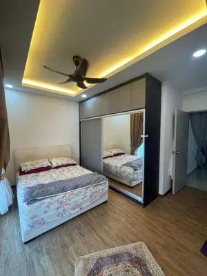 a bedroom with two beds and a mirror on the wall at coolvibes homes in Cameron Highlands