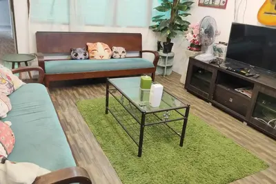 a living room with a couch with three stuffed animals on it at Kitty Home Near to Penang Hill in Ayer Itam