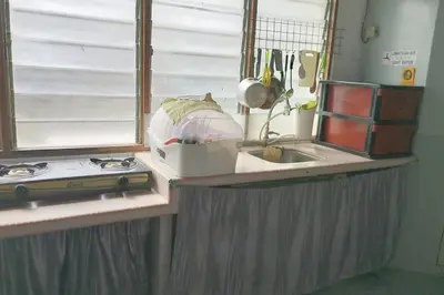 a kitchen counter with a sink and a window at Kitty Home Near to Penang Hill in Ayer Itam