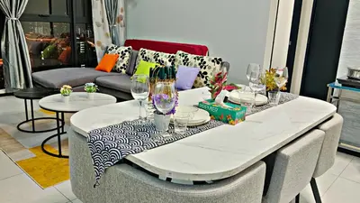 a dining room table with glasses on top of it at Apartment in Georgetown 3BR-10pax in Jelutong