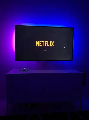 a television sitting on a table in a blue room at Double Seven Eight Homestay SemiD at Bandar Baru Setia Awan Perdana in Sitiawan