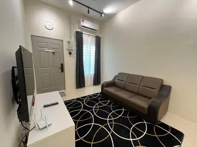 a waiting room with a couch and a tv at Double Seven Eight Homestay SemiD at Bandar Baru Setia Awan Perdana in Sitiawan