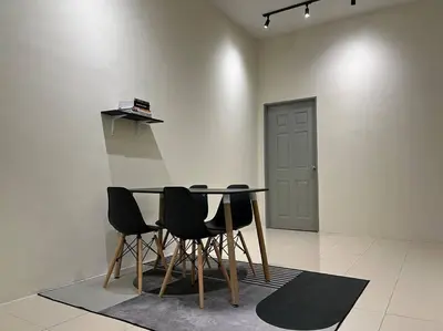 a table and chairs in a room with a door at Double Seven Eight Homestay SemiD at Bandar Baru Setia Awan Perdana in Sitiawan