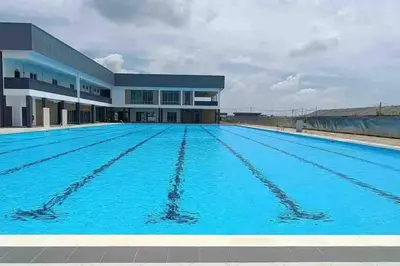 a large swimming pool in front of a building at Double Seven Eight Homestay SemiD at Bandar Baru Setia Awan Perdana in Sitiawan