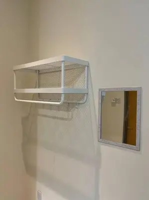 a mirror on a wall next to a white wall at Double Seven Eight Homestay SemiD at Bandar Baru Setia Awan Perdana in Sitiawan