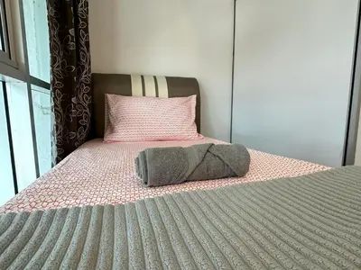 a bed with a pillow on top of it at CEOZ2 Duplex 2BR Suite #Airport #USM #SPICE #Pantai in Bayan Lepas