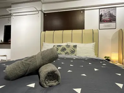 a bedroom with a large gray stuffed animal laying on a bed at CEOZ2 Duplex 2BR Suite #Airport #USM #SPICE #Pantai in Bayan Lepas