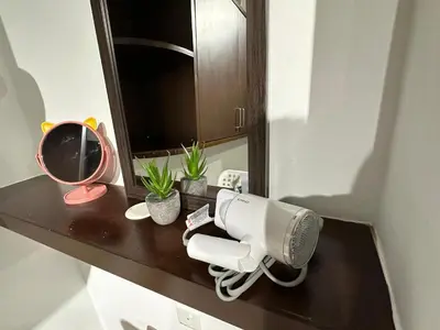 a hair dryer on a bathroom counter with a mirror at CEOZ2 Duplex 2BR Suite #Airport #USM #SPICE #Pantai in Bayan Lepas