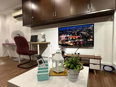 a living room with a large tv on the wall at CEOZ2 Duplex 2BR Suite #Airport #USM #SPICE #Pantai in Bayan Lepas