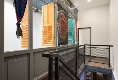 a room with a balcony with windows at Rope Walk Guest House in George Town