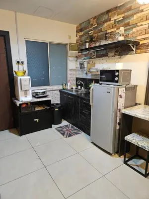 a kitchen with a sink and a refrigerator at Tower Homestay @ Muslim Friendly in Ipoh