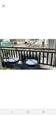 a balcony with two blue chairs on top of a building at Tower Homestay @ Muslim Friendly in Ipoh