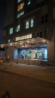 a building with lights on the front of it at night at Tower Homestay @ Muslim Friendly in Ipoh