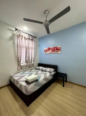 a bedroom with a bed with a ceiling fan at D' Permata Homestay Kulim in Kulim