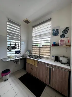 a kitchen with wooden cabinets and two windows and a sink at D' Permata Homestay Kulim in Kulim