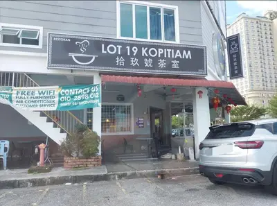 a building with a sign for a coffee shop at CY Homestay in Kampar