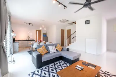 a living room with a couch and a table at Solok Sungai Emas By Plush in Batu Ferringhi