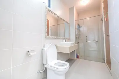a bathroom with a toilet and a sink and a shower at Solok Sungai Emas By Plush in Batu Ferringhi