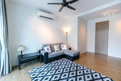 a living room with a couch and a rug at Solok Sungai Emas By Plush in Batu Ferringhi