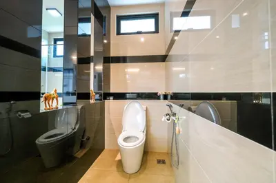 a bathroom with a toilet and a bidet at Solok Sungai Emas By Plush in Batu Ferringhi