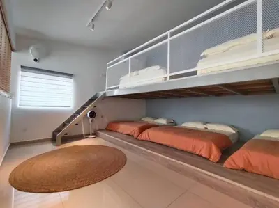 a bedroom with two beds and a staircase at Morning de Ville-Private Pool BBQ Karaoke 26-30pax in Ipoh