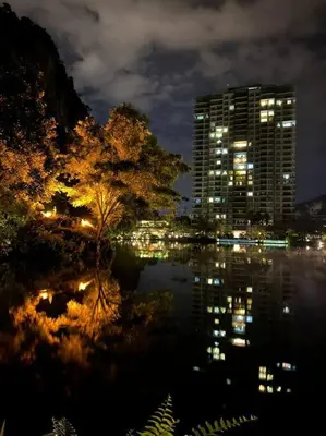 a view of a city at night with a building at Ipoh Tambun Private Unit Lakeside Residences in Kampong Batu Lapan