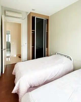 a bedroom with two white beds and a mirror at Ipoh Tambun Private Unit Lakeside Residences in Kampong Batu Lapan