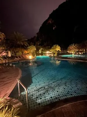 a large swimming pool at night with lights at Ipoh Tambun Private Unit Lakeside Residences in Kampong Batu Lapan
