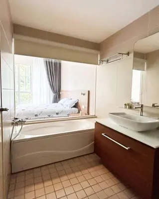 a bathroom with a bath tub and a sink at Ipoh Tambun Private Unit Lakeside Residences in Kampong Batu Lapan