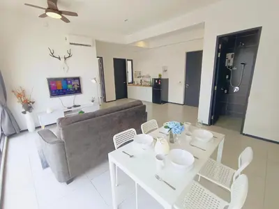 a living room with a couch and a table and chairs at Infinity Pool, Georgetown, Up to 11 Pax, 3 Bedrooms, 2 Bathrooms, 2 Car Parks by Star Home in Jelutong