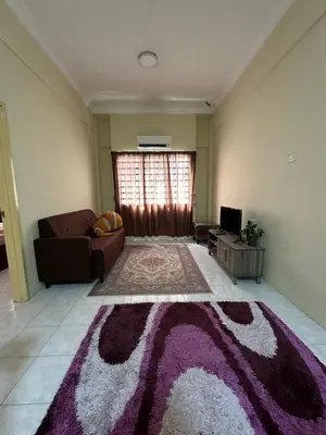 a living room with a couch and a rug at DHW Homestay in Simpang Ampat Semanggol