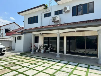 a white house with a patio in front of it at Happy Homestay in Ipoh