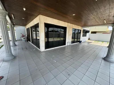 an empty patio with columns and a wooden ceiling at Happy Homestay in Ipoh