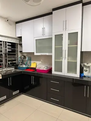 a kitchen with white cabinets and black counter tops at DOUBLE EE HOMESTAY 6 cars parking place 12pax in Sitiawan