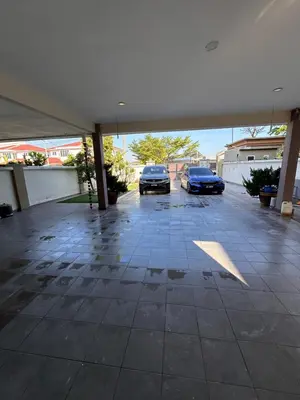 two cars are parked in a parking lot at DOUBLE EE HOMESTAY 6 cars parking place 12pax in Sitiawan