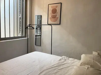 a bedroom with a bed and a picture on the wall at Aayu Melayu - George Town Penang in George Town