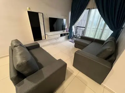 a living room with a couch and a television at Cozy Urban Retreat @ Horizon in Ipoh