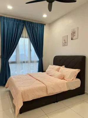 a bedroom with a large bed with blue curtains at Cozy Urban Retreat @ Horizon in Ipoh