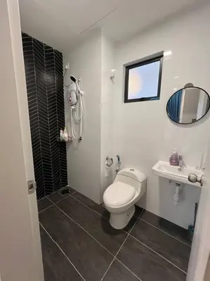 a bathroom with a toilet and a sink at Cozy Urban Retreat @ Horizon in Ipoh