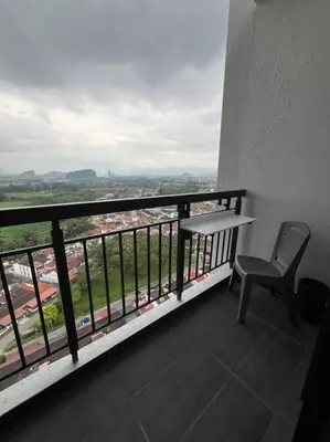 a table and a chair on a balcony with a view at Cozy Urban Retreat @ Horizon in Ipoh
