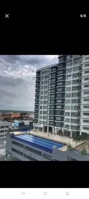 a large building with a swimming pool in front of it at 288 Sekinchan Coze Home in Sekincan
