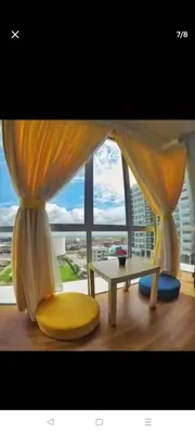 a living room with a table and a window at 288 Sekinchan Coze Home in Sekincan