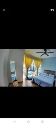 a bedroom with a bed and a mirror and a ceiling fan at 288 Sekinchan Coze Home in Sekincan