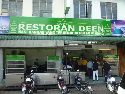 a restaurant with motorcycles parked in front of it at MUJI X Rilakkuma Seaview 3BR Georgetown with TV Box in Jelutong