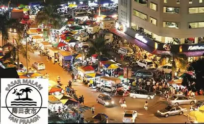 a busy city street at night with cars and people at MUJI X Rilakkuma Seaview 3BR Georgetown with TV Box in Jelutong