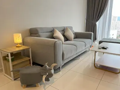 a living room with a couch and a dog toy in the middle at Rooftop - Sky Pool - 2BR Premium Homestay - Georgetown \u57ce\u5e02 6 pax in George Town